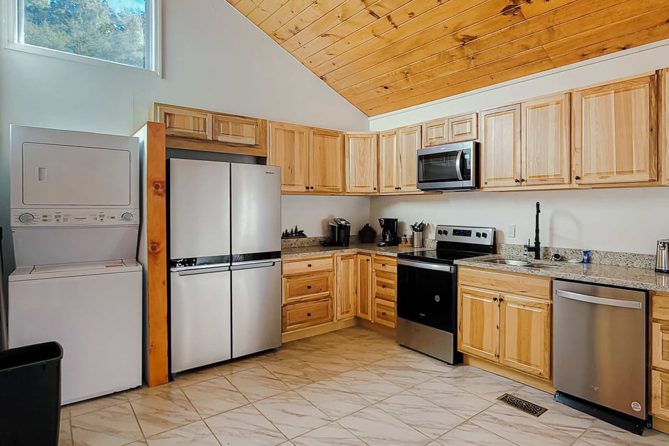 Modern appliances and natural wood charm create your culinary retreat in the Smokies!