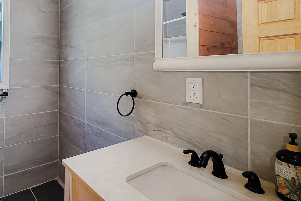 Bathroom bliss awaits. And, enjoy a sleek, modern space with elegant finishes and natural light!