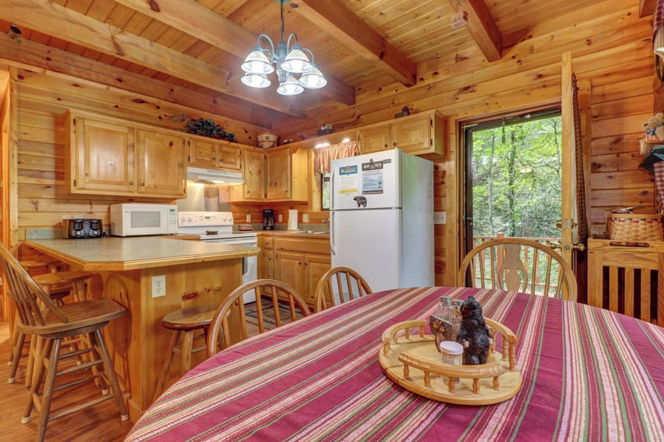 Gather around the charming table for meals and memories with woodland views!