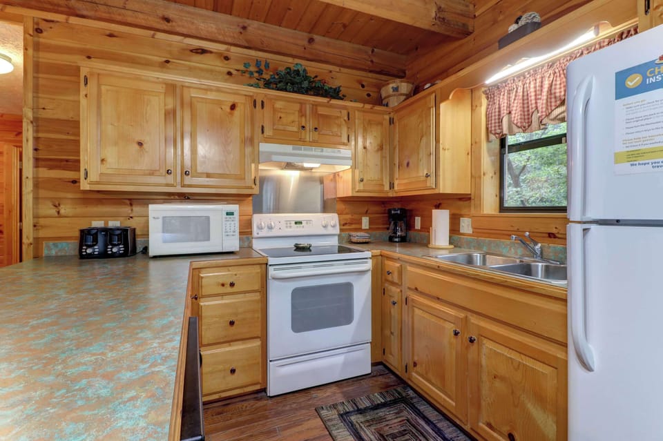 Whip up delicious meals in this charming wood-accented kitchen with modern amenities!