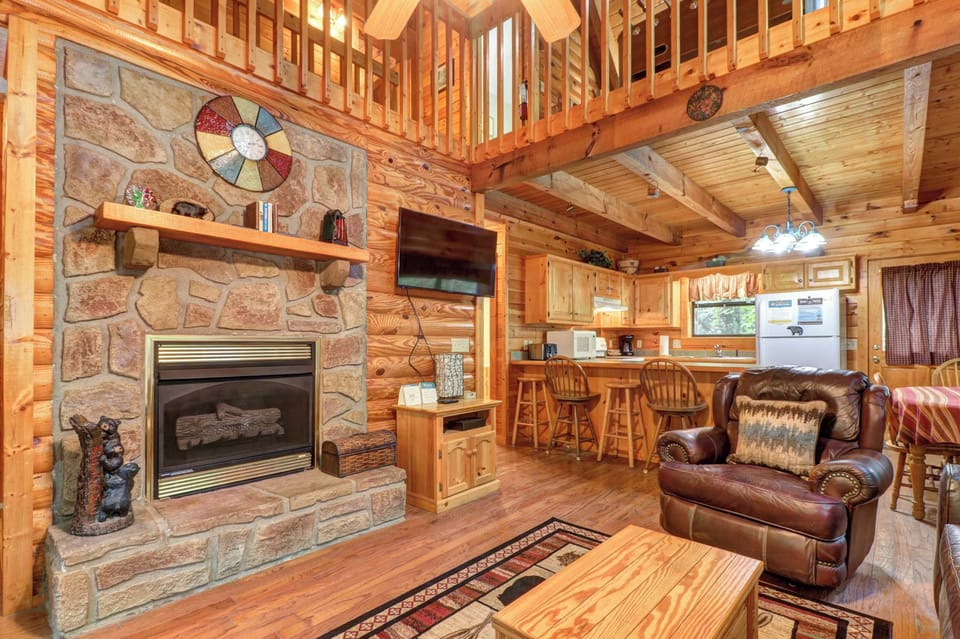 Relax by the stone fireplace in a warm, inviting space with rustic charm!