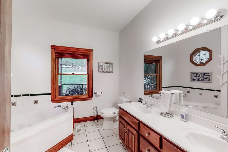 Bright and inviting with a luxurious tub and scenic garden views!