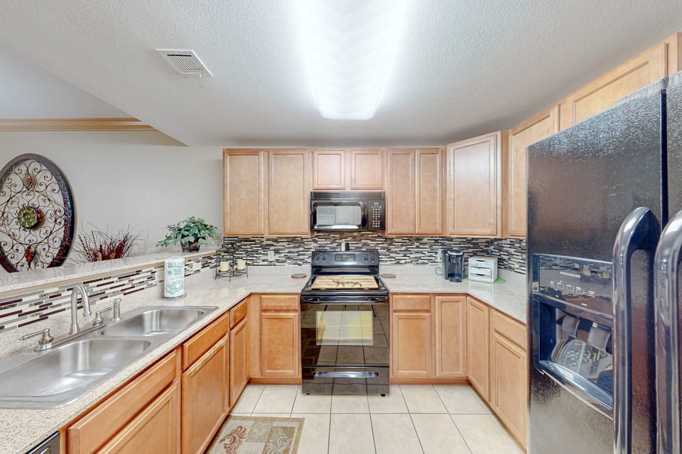 Fully equipped kitchen with stainless appliances, ample counter space, and modern finishes. Perfect for home-cooked meals and extended stays.