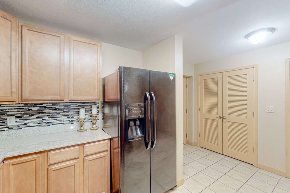 Spacious kitchen with full-size refrigerator, plenty of cabinets, and tile flooring. Great for extended stays and group vacations.