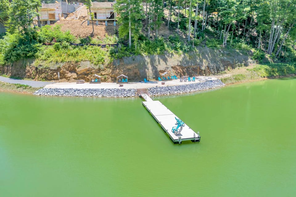 Take in the full beauty of this lakefront retreat, showcasing the private dock, beach area, and peaceful surroundings.
