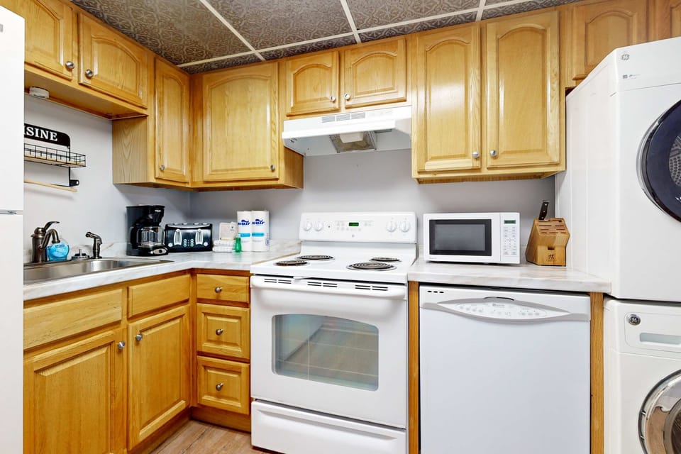 Whip up culinary delights in this modern space with sleek appliances and warm wood accents!