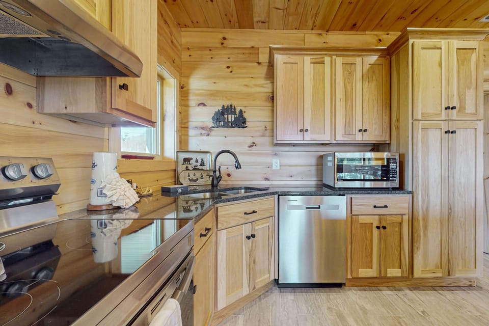 Modern appliances and rustic charm make cooking a joy in this inviting space!