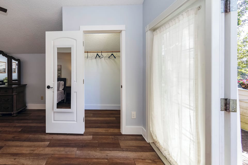 2 closets with hangers and mirrors