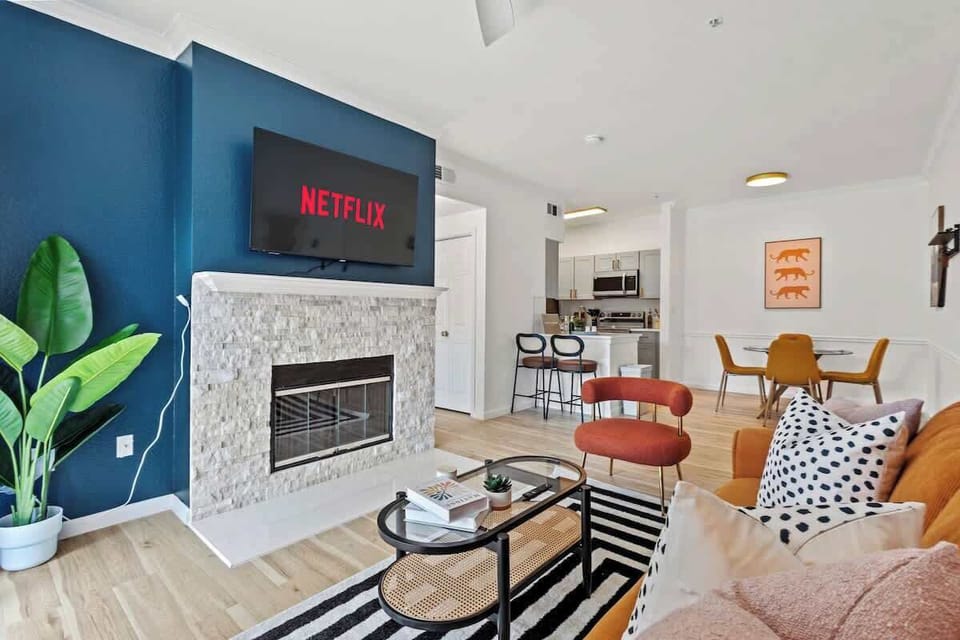 Elegant living room with a modern fireplace, chic decor, and cozy seating. A warm and inviting spot for relaxing evenings.