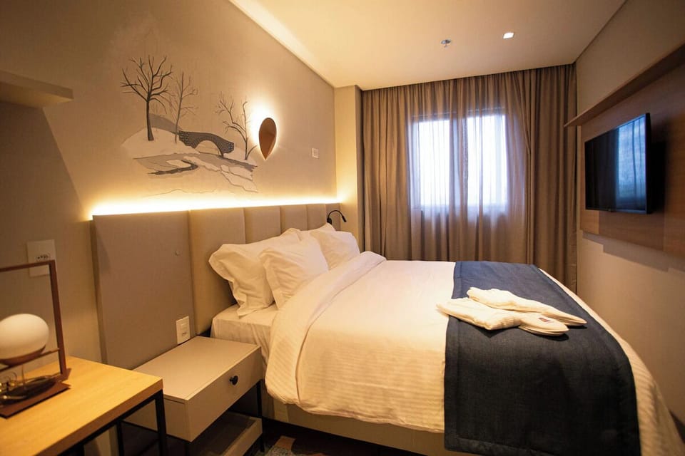 Settle in for a cozy night with TV and plush bedding.