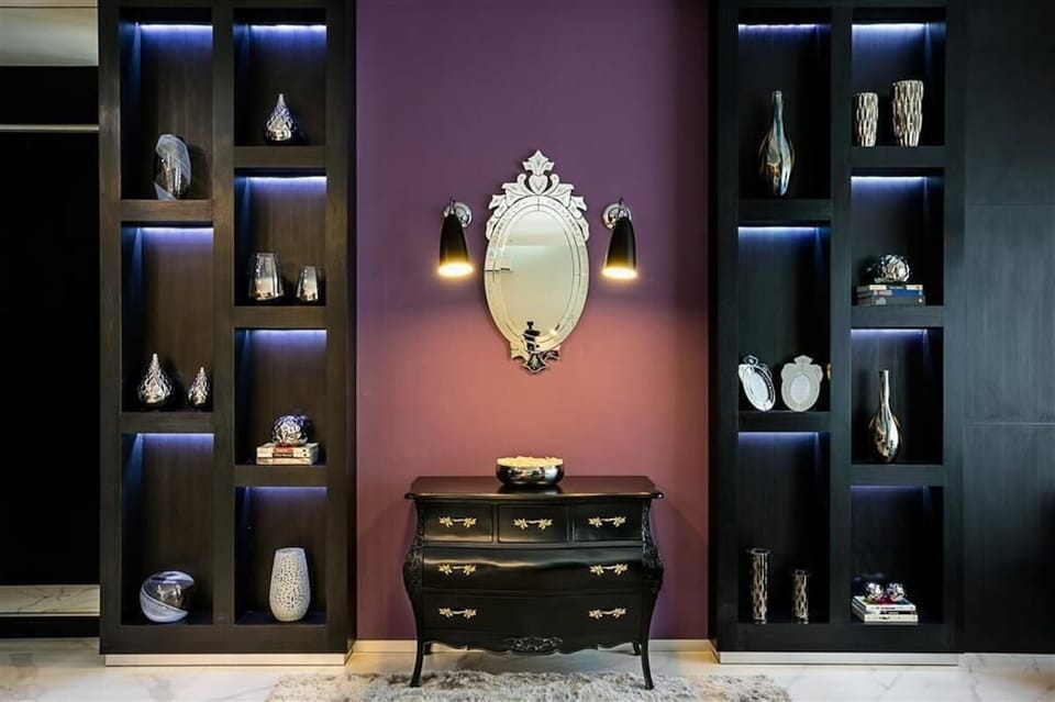 Admire boutique details with softly lit shelves and statement mirror.
