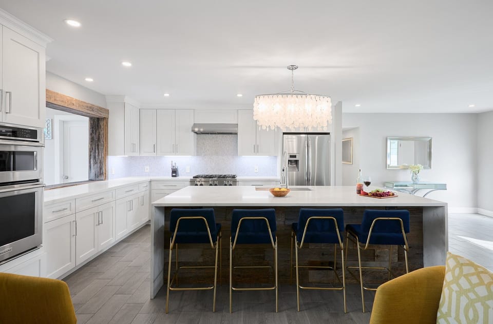Fully equipped kitchen with stainless steel appliances, a sleek kitchen island with a breakfast bar for casual seating for 4.