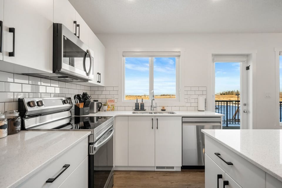 Fully equipped kitchen with stainless steel appliances and countryside views