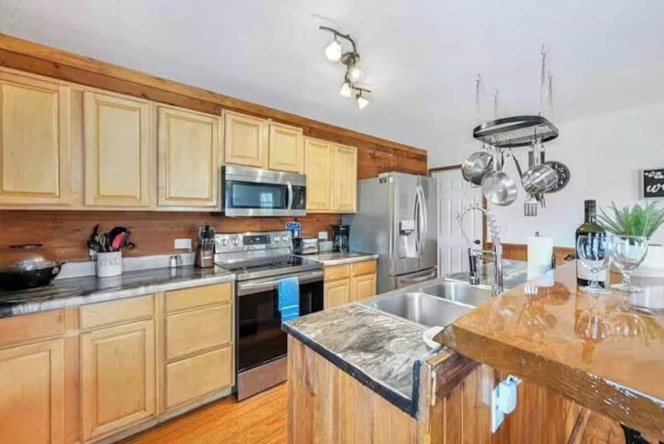 Fully equipped kitchen with modern appliances and cookware.