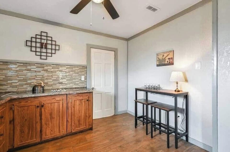 Functional kitchen setup with a table and stylish lamp accent.