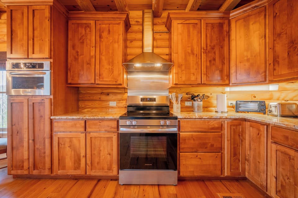 Well equipped kitchen with full size stove and cabinets.