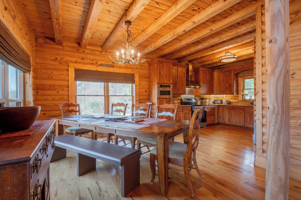 Warm dining area with large wooden table and chairs.