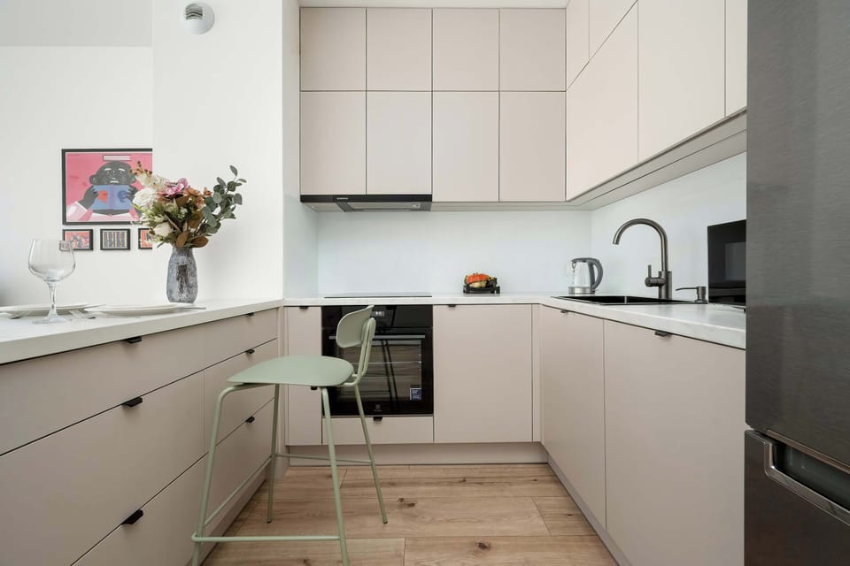 The sleek design of the kitchenette blending seamlessly with the living area.