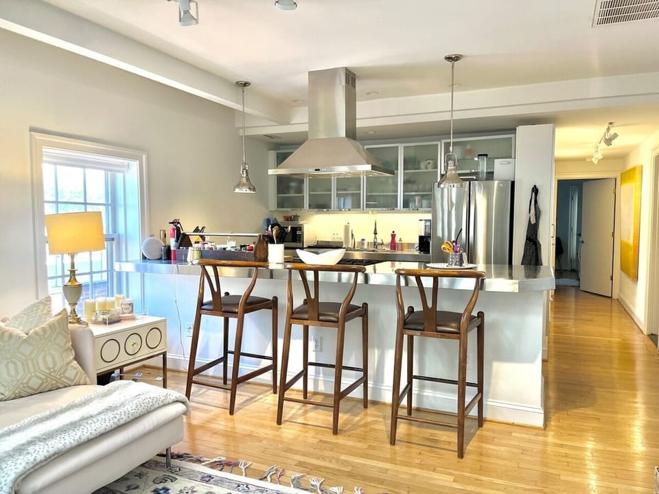 Stainless steel kitchen with Bosch dishwasher, new fridge, coffee maker, microwave, and fully stocked for cooking/eating