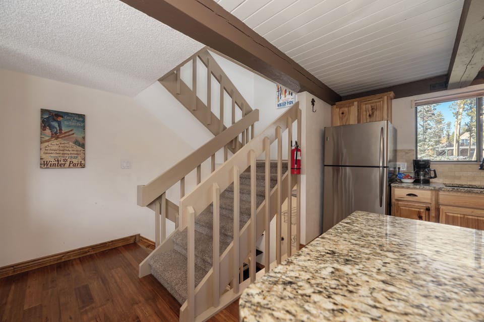 Your mountain chalet features a modern kitchen with granite countertops, stainless steel appliances, and rustic wood cabinets for cozy meal preparation.