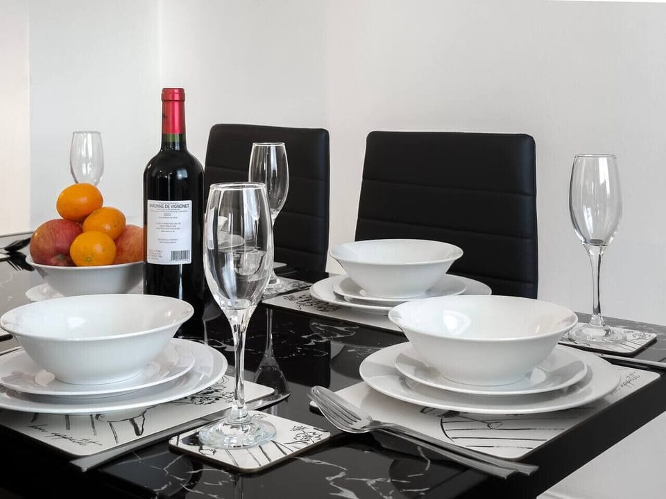 Dining table set with wine and fresh fruit
