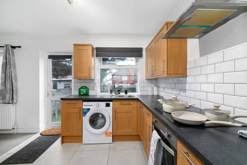 Kitchen with washing machine and garden access