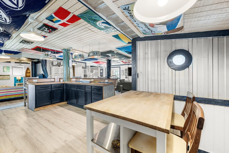 Cozy dining area with nautical decor and an open kitchen layout.