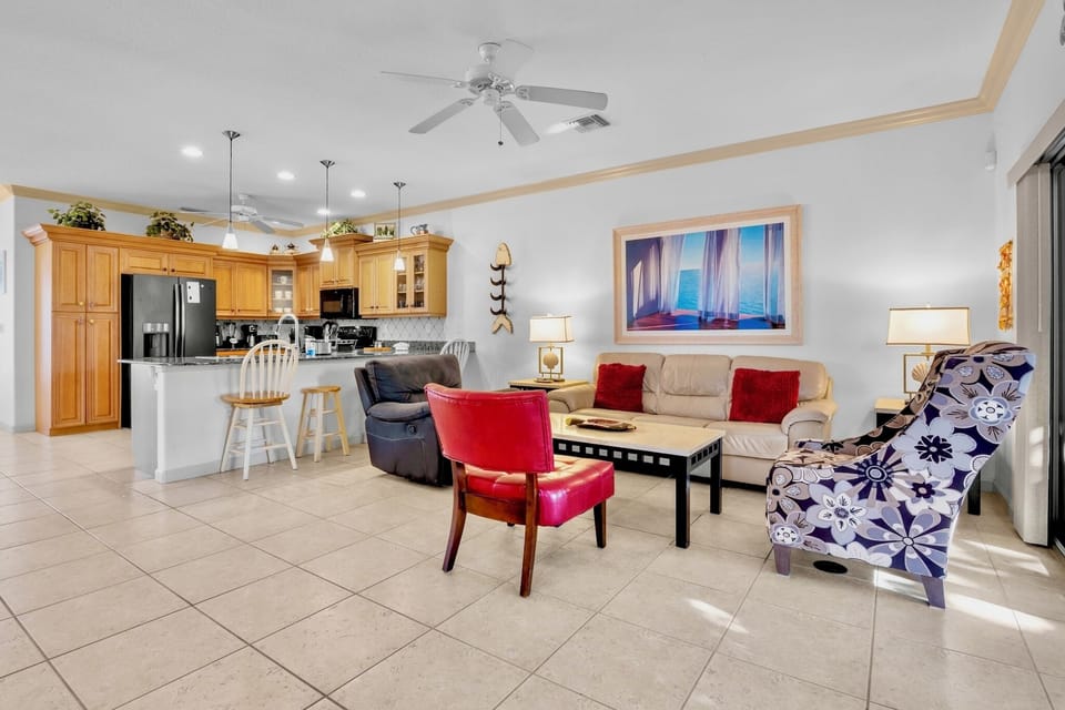 Your spacious open-plan living area seamlessly blends comfort and style with cozy seating, a fully equipped kitchen, and warm natural light throughout.