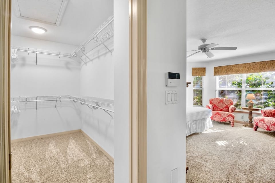 Store your belongings with ease in this spacious walk-in closet featuring organized shelving and ample hanging space for your entire wardrobe.