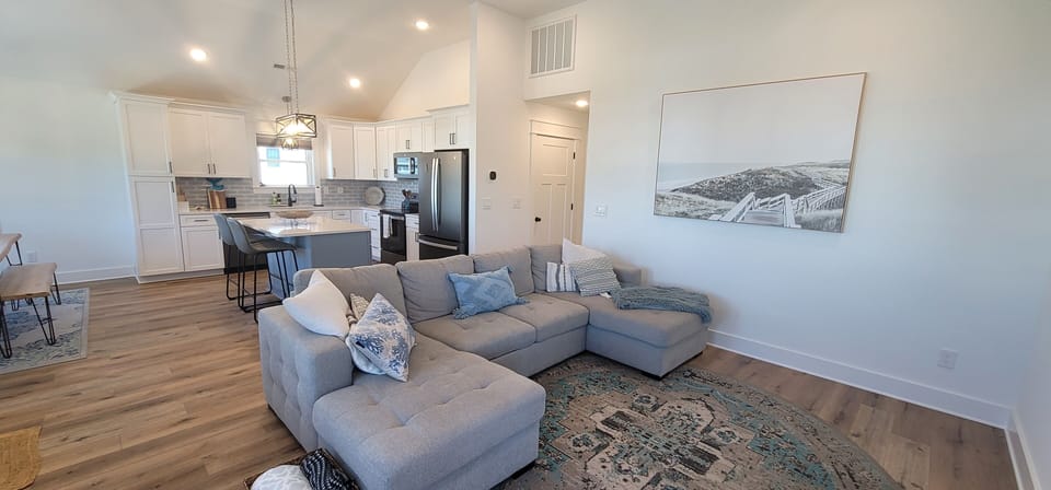 Large comfy couch and open concept kitchen and dining. 