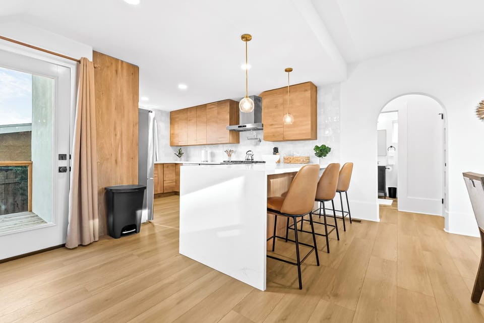 Bright kitchen with island seating and warm wood cabinets.