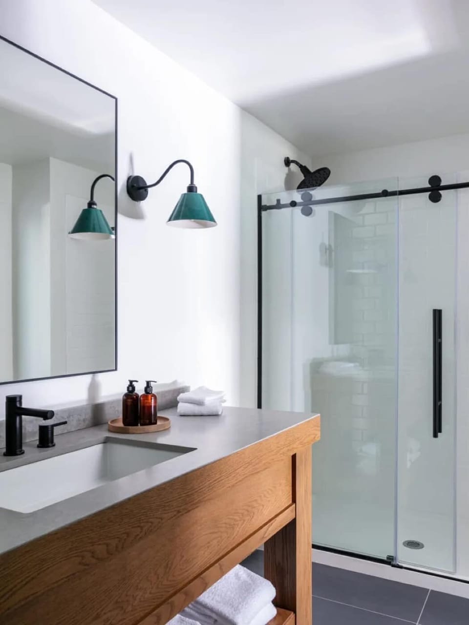 Freshen up in a sleek bath with glass shower doors.