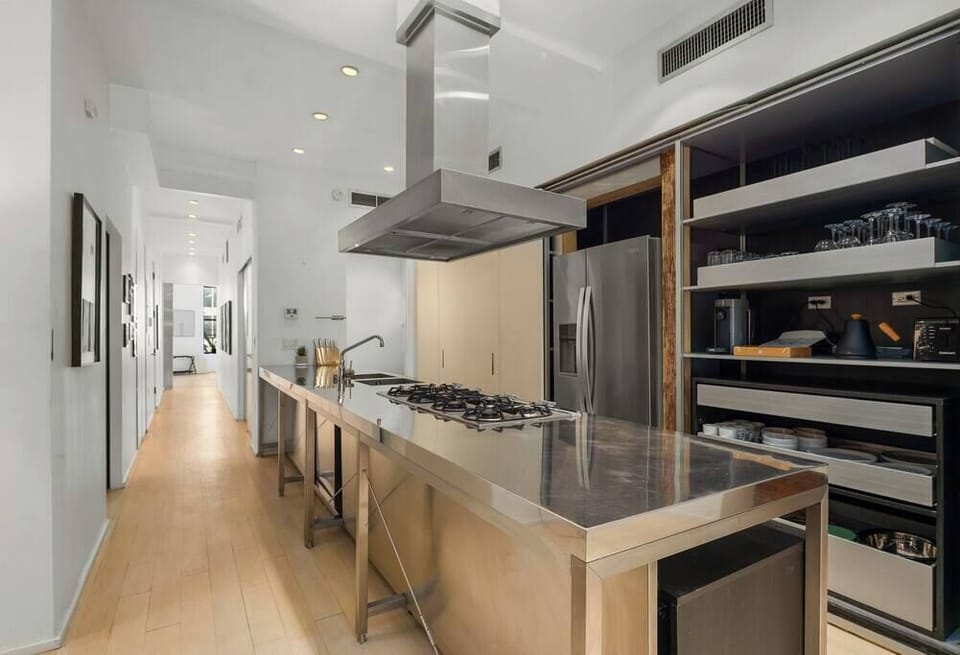 Massive kitchen with commercial-grade appliances and prep station.