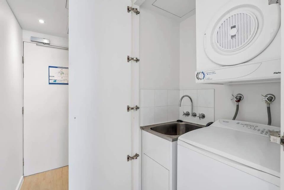 A private laundry with a washer, dryer and utility sink ensures extended stays feel seamless and self-sufficient.