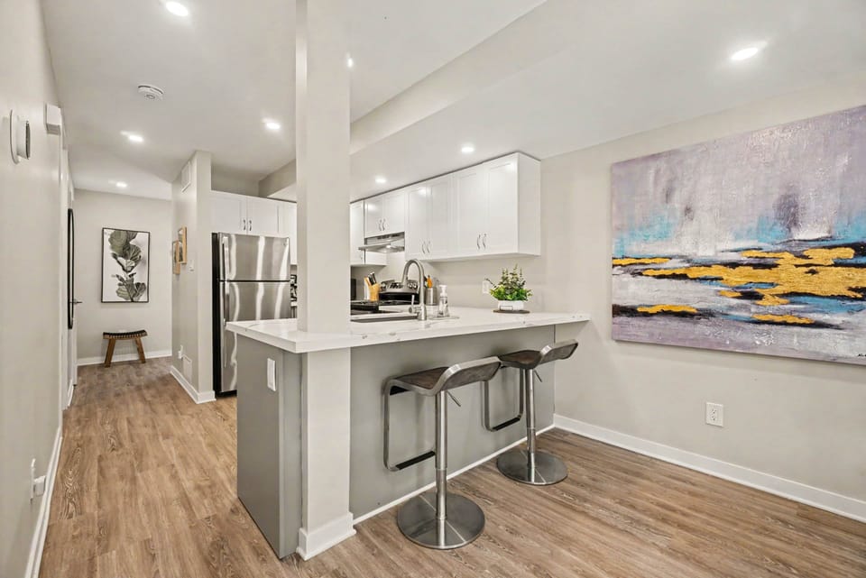 Modern kitchen breakfast bar featuring barstools and a view of the cooking and dining area