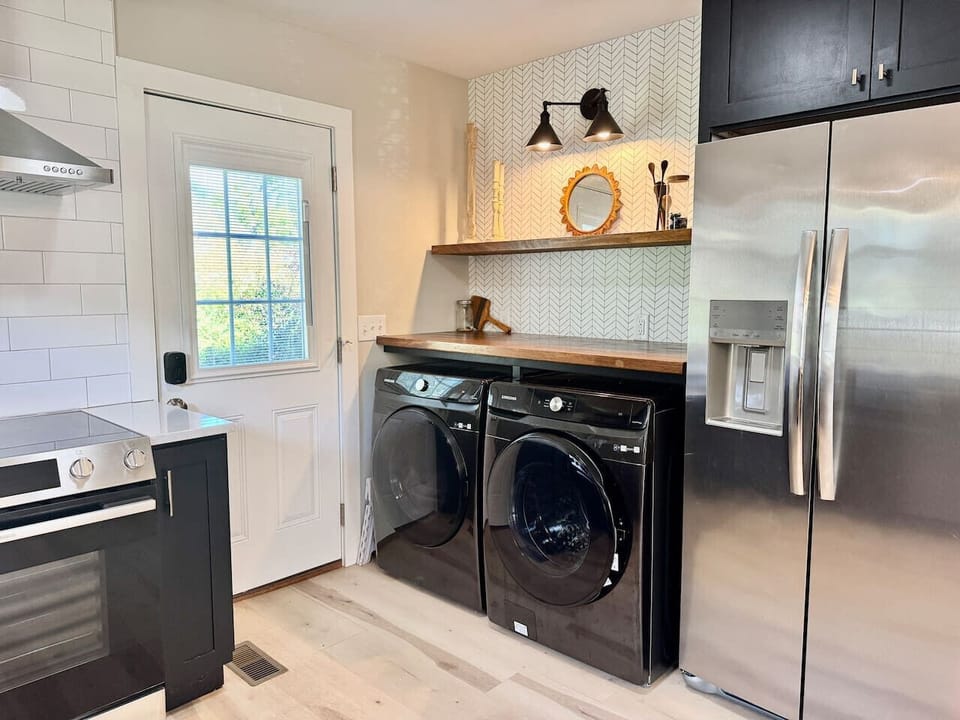 Mountain-ready kitchen with washer, dryer, and fridge with water filter.