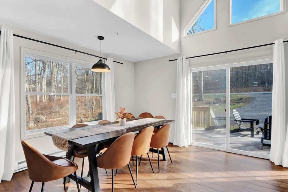 Dining Area with Large Windows and Scenic Woodland Views