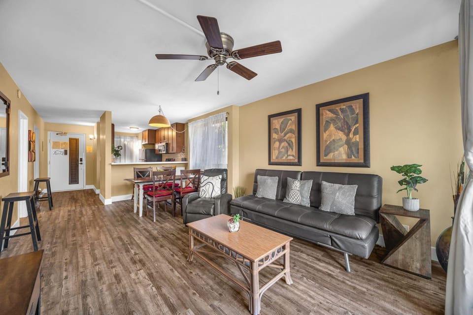 Relax in an open living space with a queen sleeper sofa, smart TV, and cooling ceiling fans.