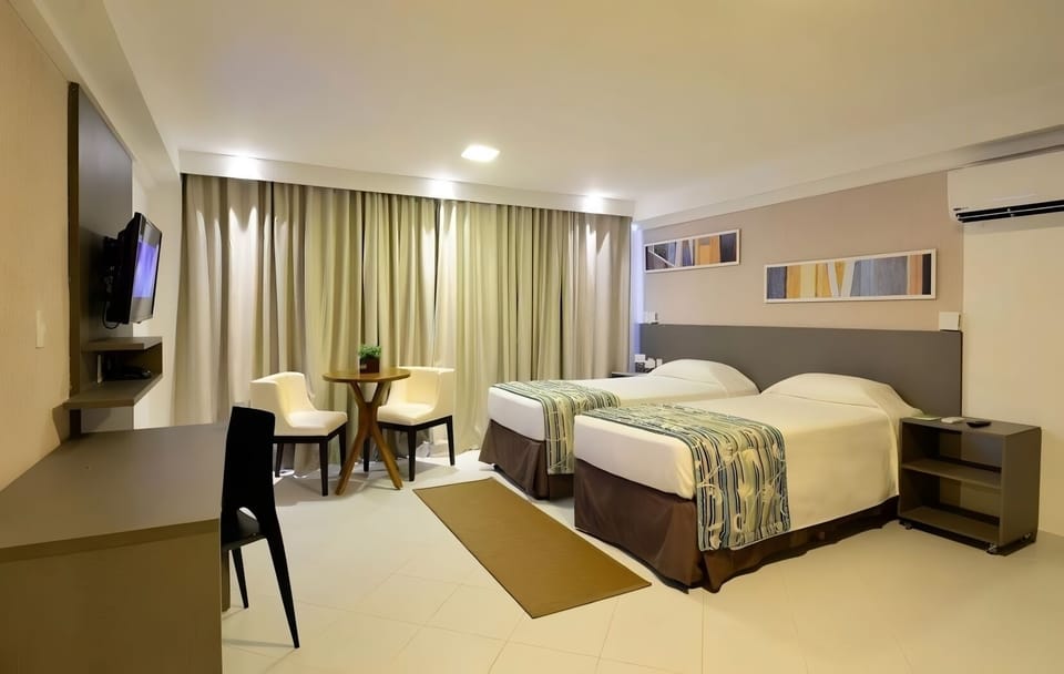 Start mornings bright in twin beds beside a sunny window nook.