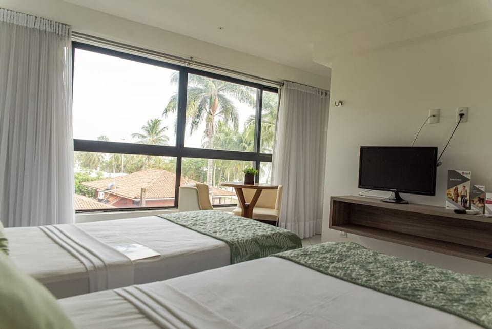 Drift off comfortably in twin beds with airy, calm decor.