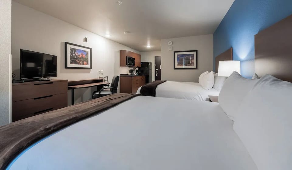 Settle in with roomy beds, workspace, and convenient in-room kitchenette.