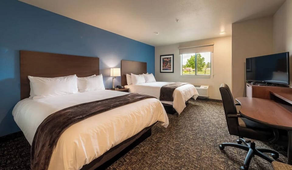 Unwind in a bright double-queen room with cozy linens.