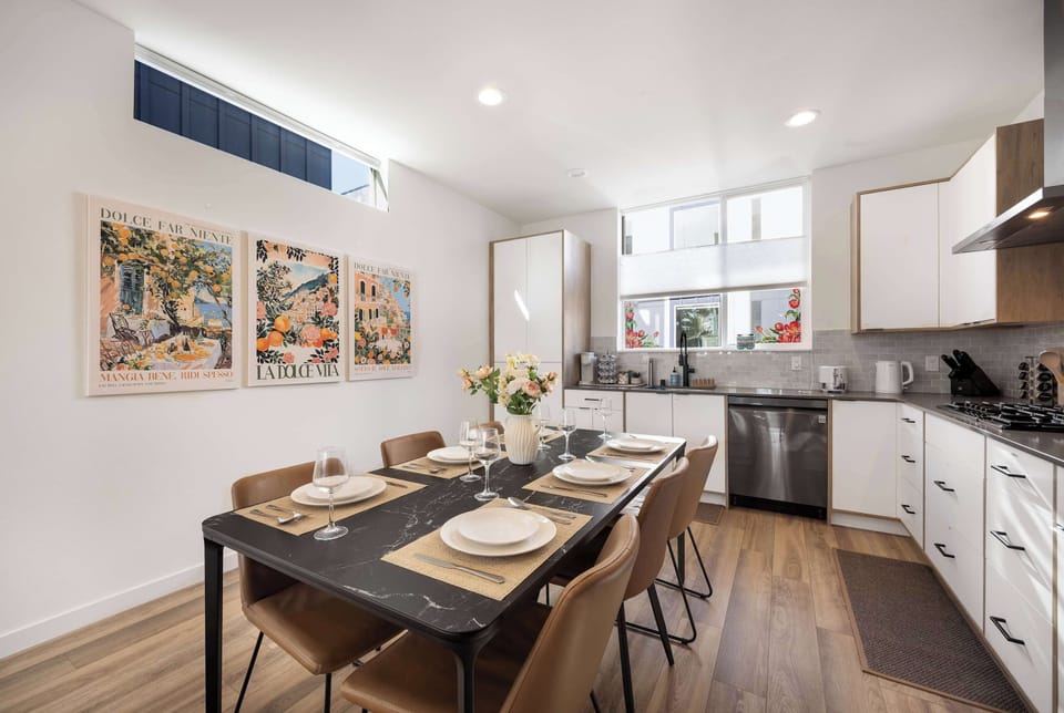 Stylish dining area framed by vibrant Mediterranean-inspired artwork.