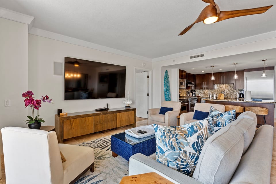 Sleeper sofa offers extra sleeping space in this stylish living room with wall-mounted TV