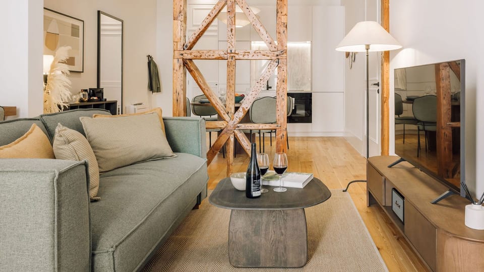 Modern dining and living space with natural light, warm wood flooring, minimalist furniture, and stylish decor. 
#InteriorDesign 
#ModernLiving 
#CozyHome 
#Minimalism
#AndoLiving