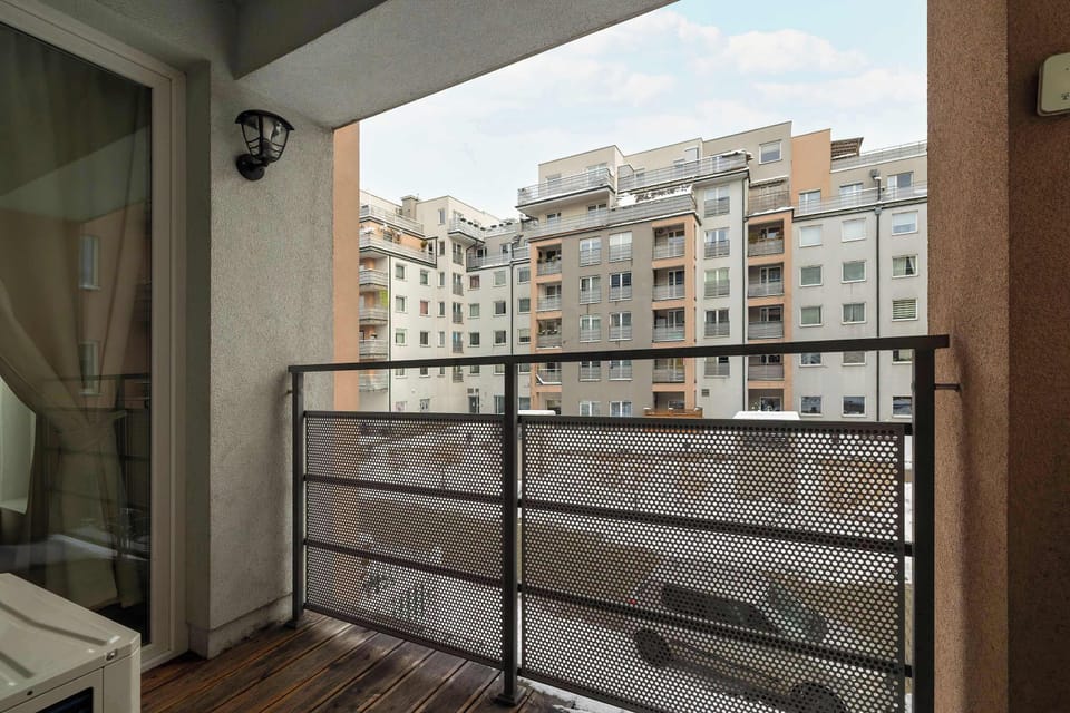Balcony overlooking modern residential buildings.