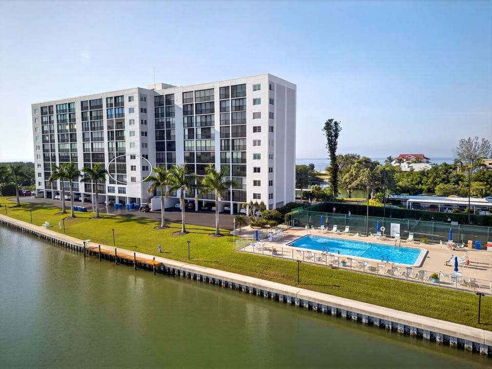 The. unit 404 is circled in white. Views of the water, nature and pool area