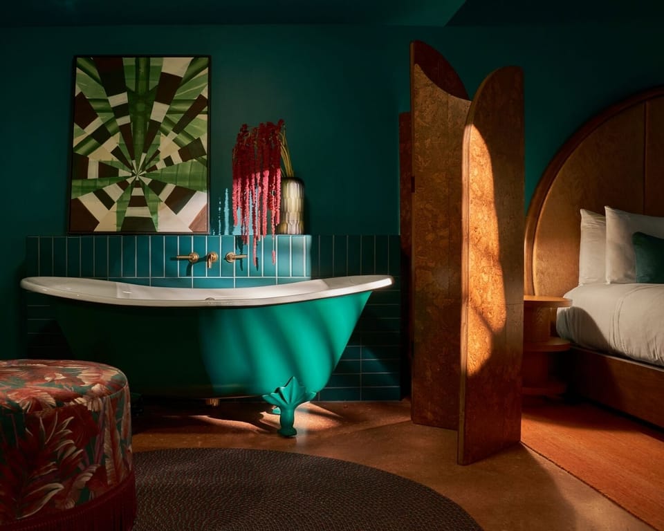Indulge in a dramatic soaking tub beside your serene bed.