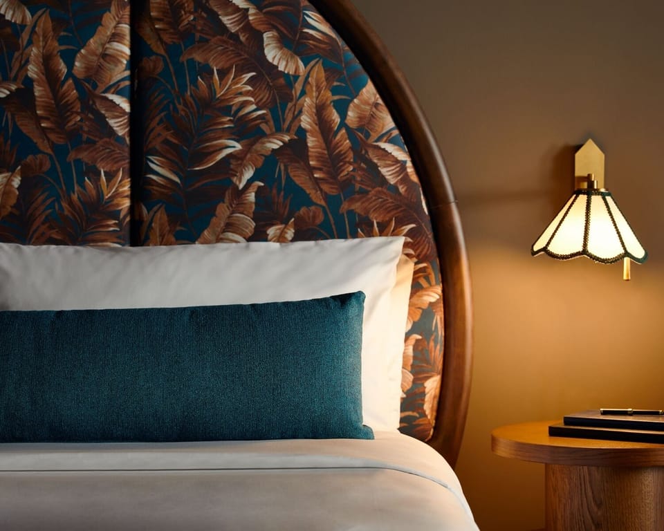 Relax into crisp bedding framed by a striking statement headboard.