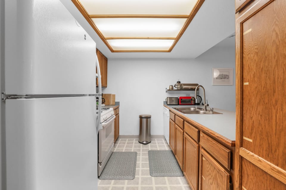Cook up your favorite meals in this well-equipped kitchen, featuring essential appliances and ample counter space.